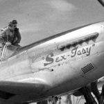 Vintage Fighter Pilot climbing out of his plane the _Sex-tasy_ 1945 Mariannas Islands